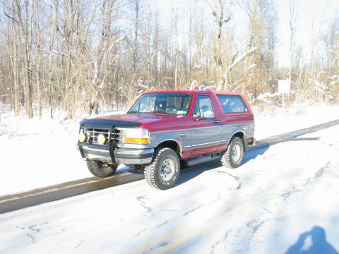 1995 Ford Bronco - Red and gray 1995 Ford Bronco in a snowy landscape.