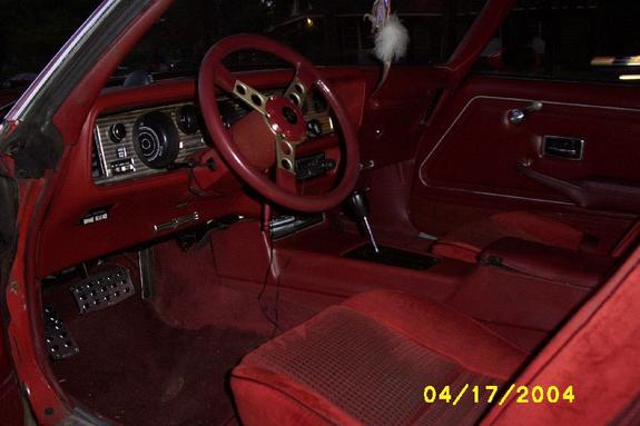 Red car interior with steering wheel, floor shifter and red seats