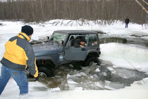2003 Jeep TJ - A Jeep Wrangler TJ attempts to cross a partially frozen body of water during winter.