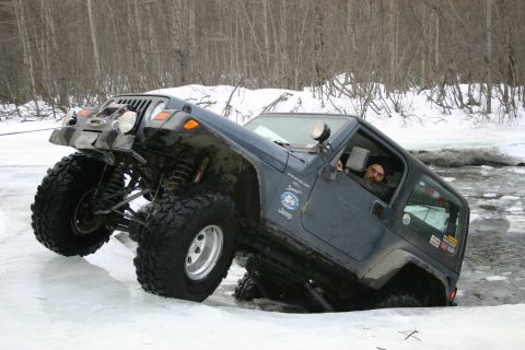 2003 Jeep TJ - Jeep TJ off-roading in winter conditions, driving through ice and snow.
