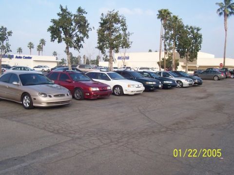 2002 Ford Taurus - A row of sedans, including a tan 2002 Ford Taurus, are parked in a lot on January 22, 2005.