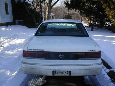 1979 Ford Bronco - Rear view of a white Mercury Grand Marquis with a license plate visible.