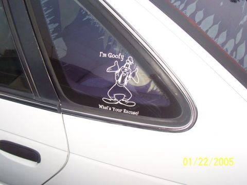 2002 Ford Taurus - White vinyl decal of Goofy reading 'I'm Goofy What's Your Excuse' on a car's rear quarter window, dated 2005.