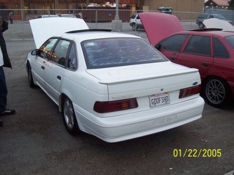 2002 Ford Taurus - White Ford Taurus SHO with custom license plate 'GOOF SHO' and aftermarket wheels.