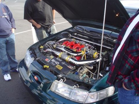 2002 Ford Taurus - The engine bay of a 2002 Ford Taurus, a modified intake system and custom engine components.