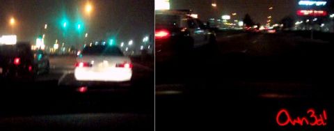 2002 Ford Taurus - A white 2002 Ford Taurus is seen from behind while driving on a highway at night, with other vehicles and city lights in the background.