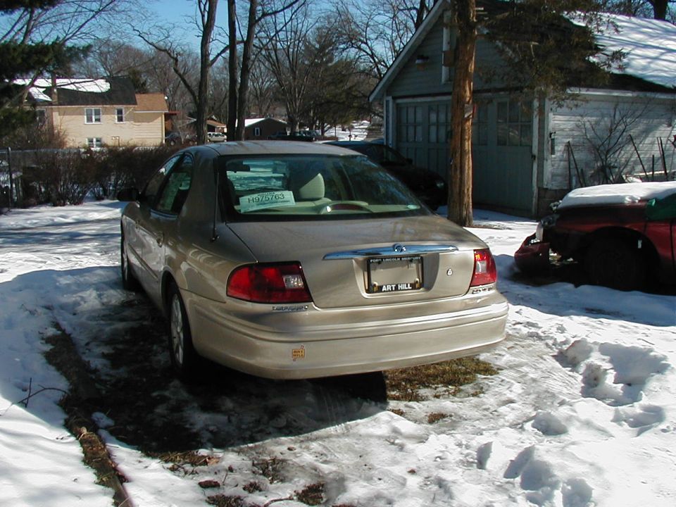 2001 Mercury Sable rear view in snow, with another car partially visible to the right