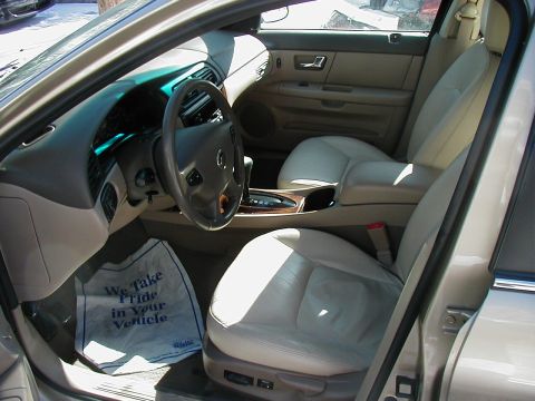 2001 Mercury Sable - Interior view of a car, leather seats and a prominent floor mat with text.