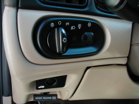 2001 Mercury Sable - Close-up of car interior controls, including a headlight switch and brake release lever.