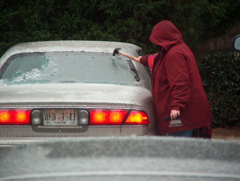 Rear of a 1998 Ford Taurus with ice on windows, license plate AHB 3543