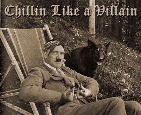 1990 Ford Bronco - A man resembling Adolf Hitler sits in a lounge chair outdoors with a dog standing behind him.