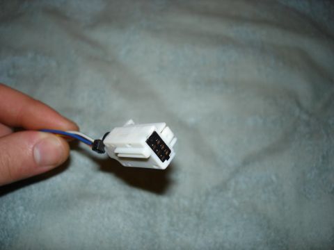 1999 Ford Contour - A white electrical connector with multiple wires is held by a hand, with a website address visible in the corner.