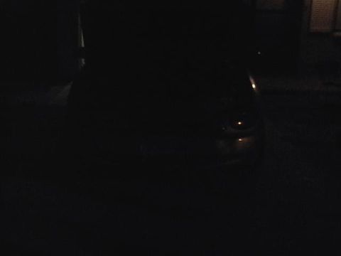 1999 Ford Taurus - Photo is too dark to identify any vehicle or details.