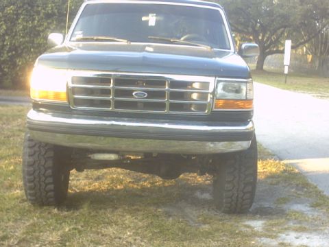 1992 Ford Bronco - Front view of a lifted 1992 Ford Bronco with prominent grille and headlights.
