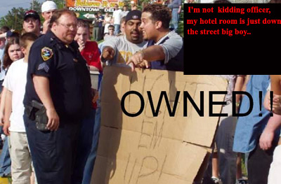 1990 Ford Taurus - People react to a cardboard sign held by a group, with a police officer present.