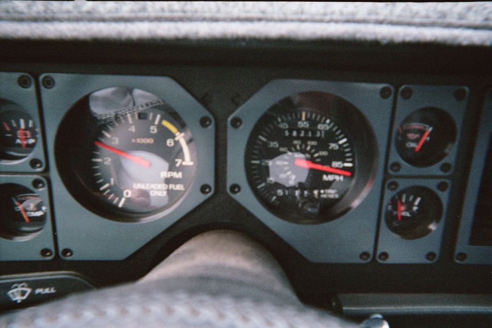 1985 Ford Mustang dashboard with tachometer, speedometer, fuel, and temperature gauges