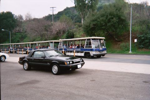 1985 Ford Mustang - Black 1985 Ford Mustang convertible seen with a Universal Studios tram in the background.
