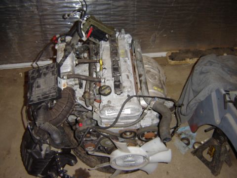 1992 Ford Bronco - Engine assembly, likely a diesel, with various components attached. No vehicle is visible.