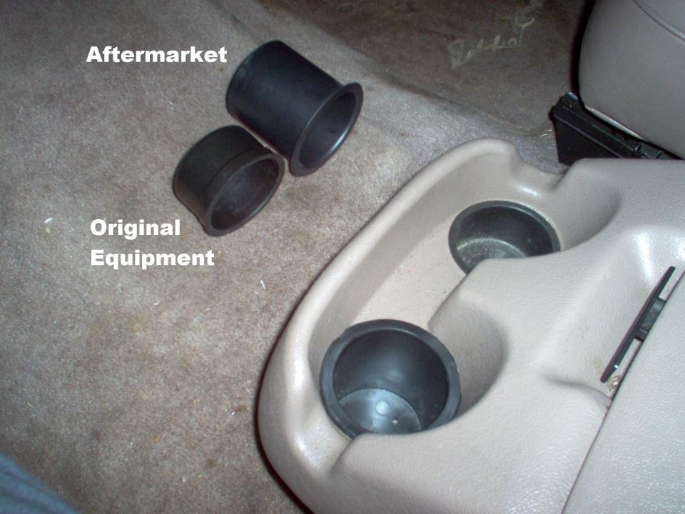 Aftermarket vs original equipment cup holder inserts on carpet near tan console