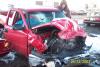 1990 Ford Taurus - A red pickup truck sustained heavy damage to its front end after a collision.