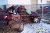 1990 Ford Taurus - Two damaged vehicles are visible in an outdoor area with snow on the ground.