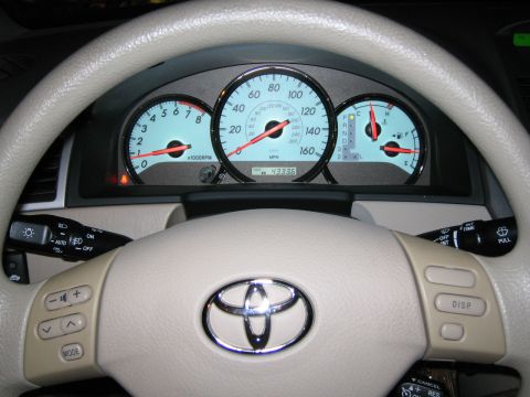 2004 Toyota Solara - Interior view of a car's dashboard and steering wheel, displaying illuminated gauges and odometer reading.