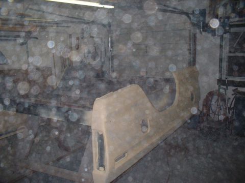 1978 Ford F-250 - A disassembled truck fender and bed panel sits in a workshop environment.
