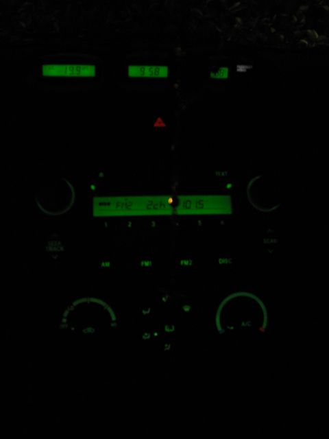 2004 Toyota Solara - The dashboard lights up with green displays for the radio, time, and temperature controls.