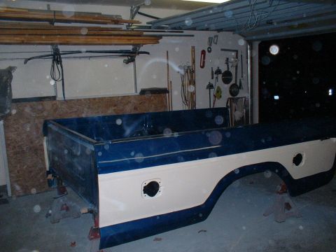 1978 Ford F-250 - A pickup truck bed is shown on jack stands inside a garage, with tools on the wall behind it.
