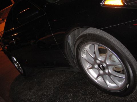 2004 Toyota Solara - Silver BBS wheel on the front fender of a black car.
