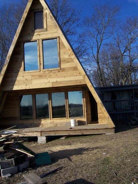 1999 Jeep TJ - This A-frame cabin is in the process of being built, with materials scattered around the site.