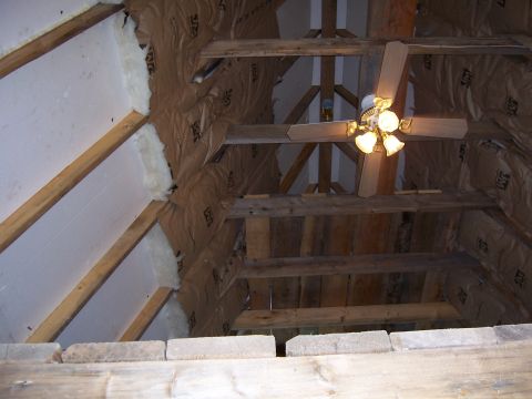 1999 Jeep TJ - Attic construction shows insulation and wooden beams, with a ceiling fan overhead.