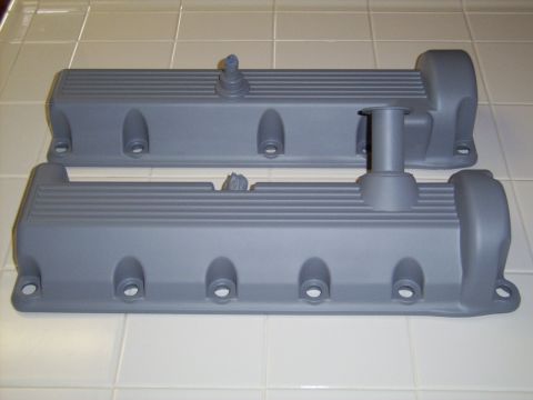 2002 Ford Mustang - Two gray valve covers are shown on a tiled surface.