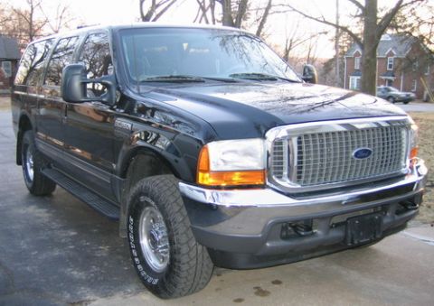 2001 Ford Excursion - A black Ford Excursion SUV is shown from the front 3/4 angle, parked outdoors.