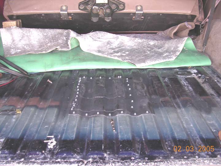 Caulked and sheetmetal screwed in place.  Not the prettiest thing, but should fill my needs.  i used a piece of floor from another rig (and the other pieces i cut out welded to it for more strenght) as the panel.  Its roughly 12 by 9 inches