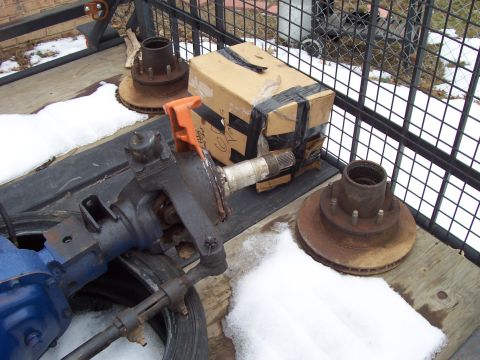 1994 Ford Bronco - Close-up of a steering knuckle assembly, brake rotor, and hub, possibly for a truck or SUV.