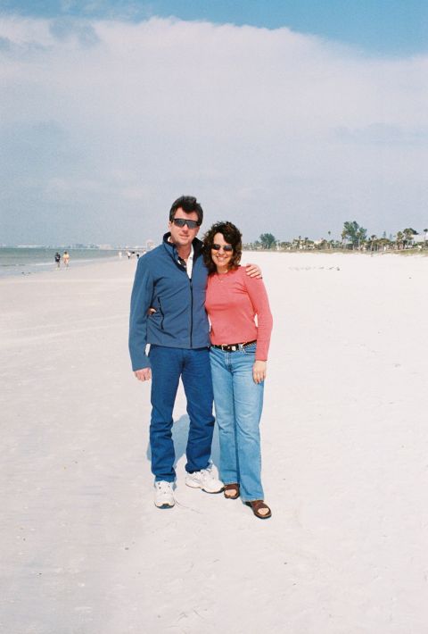 1994 Ford Bronco - A man and woman pose for a photo on a bright, sunny day at the beach.