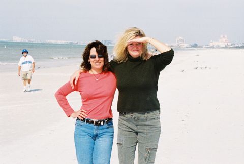 1994 Ford Bronco - Two women enjoy a day at the beach, with a man walking in the background.