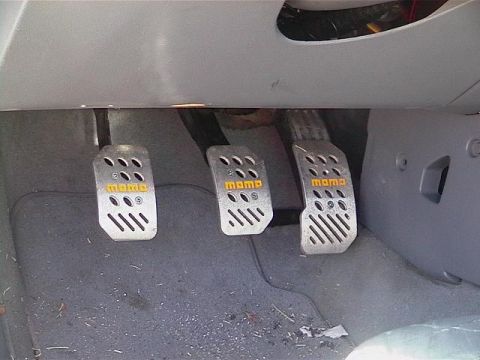 1995 Ford Contour - Aftermarket Momo pedal covers are visible in the driver's footwell.