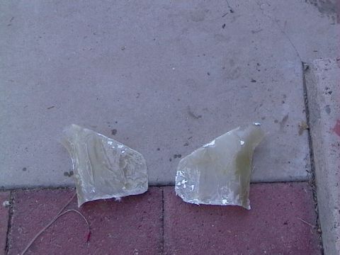 1995 Ford Contour - Two unfinished fiberglass automotive parts are shown resting on a paved surface, with a Supermotors.net watermark visible.