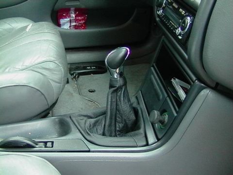 1995 Ford Contour - Interior view of a 1995 Ford Contour, focusing on the center console and gear shifter.