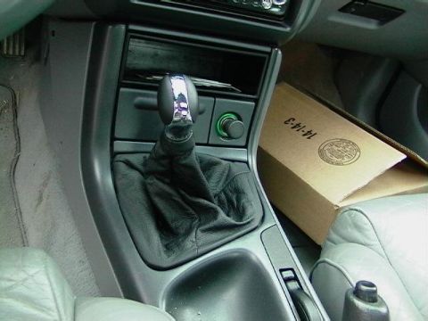 1995 Ford Contour - Interior view of a car's center console and gear shifter, with a cardboard box present.