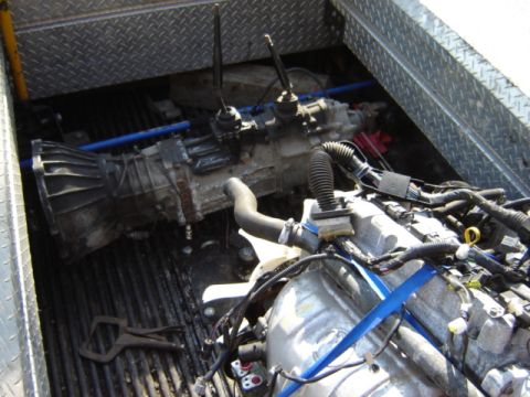 1992 Ford Bronco - Engine and transmission components are loaded into the bed of a truck, ready for transport or installation.