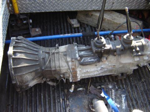 1992 Ford Bronco - Transmission and transfer case assembly with two shifter levers, likely for a 4x4 vehicle.