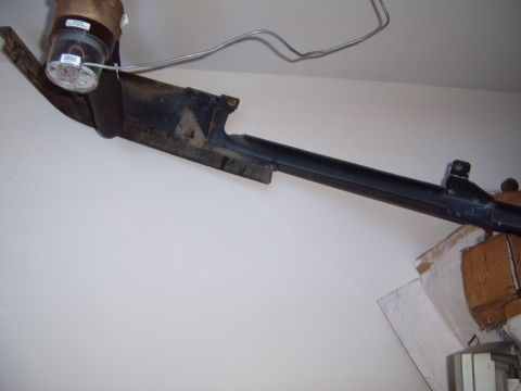 1988 Ford Bronco - Unidentified black metal automotive part mounted near a light fixture.