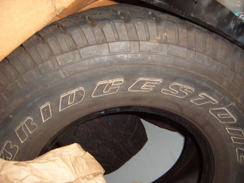 1988 Ford Bronco - Close-up view of a Bridgestone tire, showing tread pattern and branding.