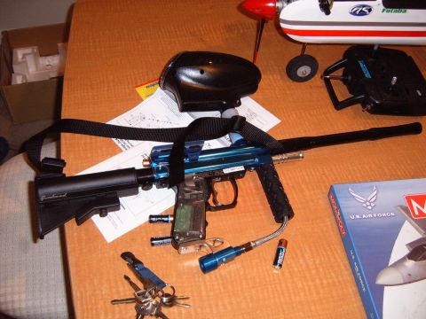 1988 Ford Bronco - A blue paintball gun and a model airplane are displayed on a wooden surface, along with a remote control and keys.