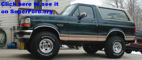 1995 Ford Bronco - This 1995 Ford Bronco is parked in front of a house, showing its side profile and tan accents.