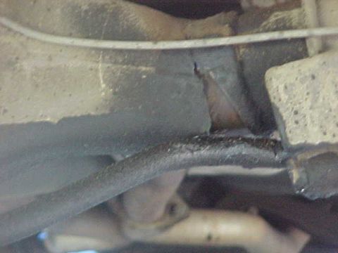 1973 Ford Ranchero - Close-up view of aged vehicle underbody components, indicating wear and tear.