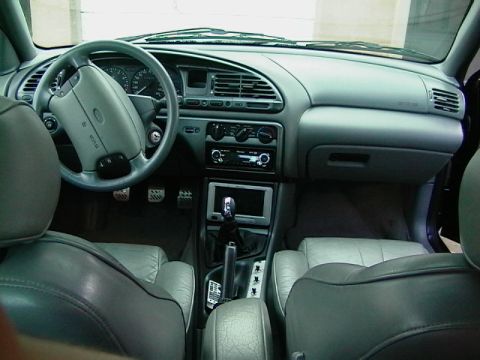 1995 Ford Contour - Interior view of a 1995 Ford Contour, showing the dashboard, steering wheel, and seating.